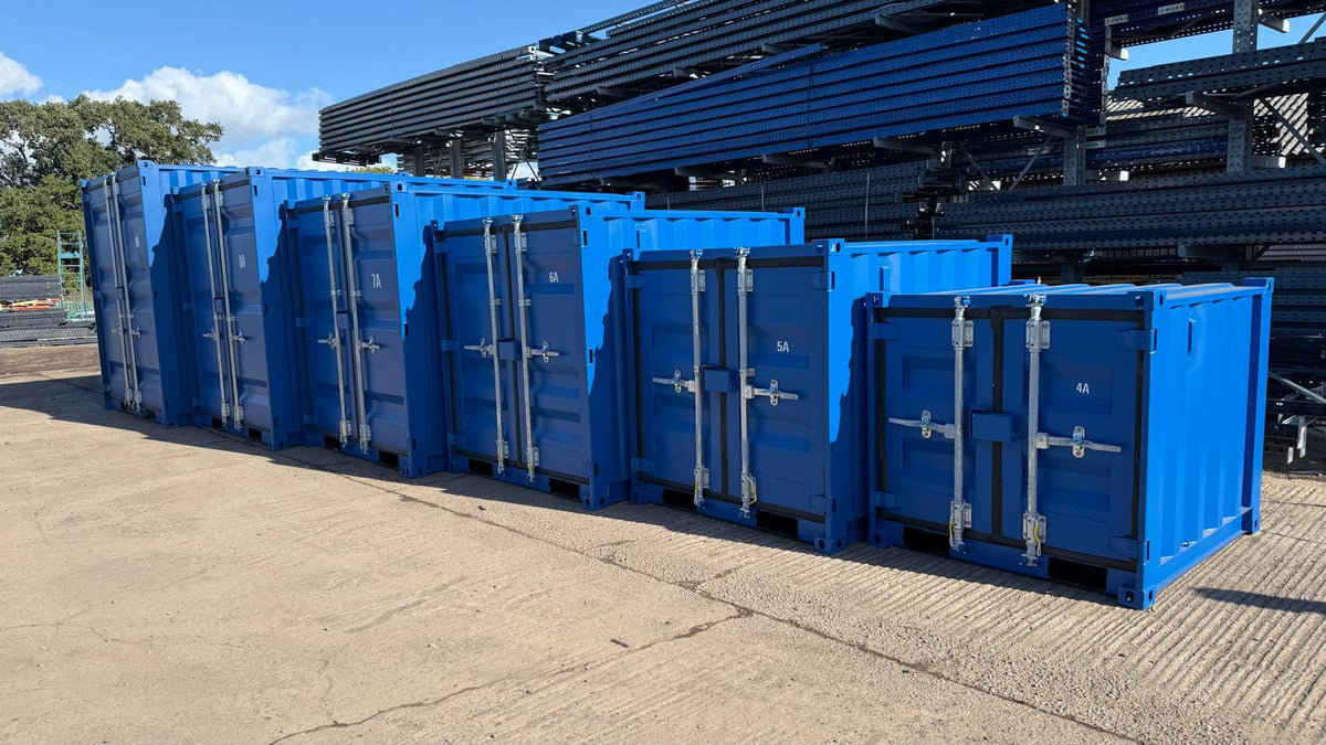 Angled view of the blue steel storage container range with double front doors and external locking bars.