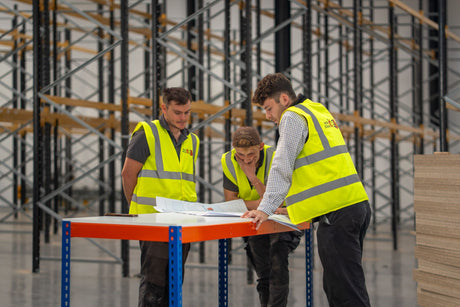 Rack It Stack It installers reviewing the CAD layout drawing in front of the Link 51 pallet racking in Milton Keynes