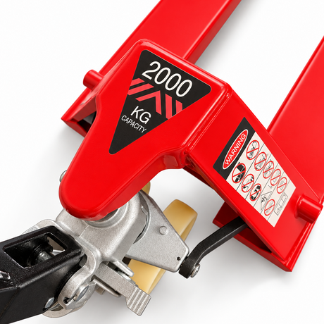 Close-up of the red 2000kg pallet truck head showing the 2000 KG CAPACITY decal and the safety warning label