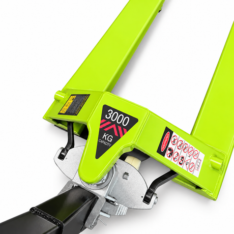 Close-up of the lime green wide fork pallet truck head showing the 3000 KG CAPACITY decal