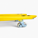 Underside of the yellow pallet truck forks showing the paired tandem load rollers on their linkage