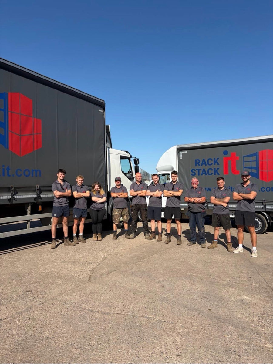 The Rack It Stack It team standing in front of two Rack It Stack It curtain-side lorries