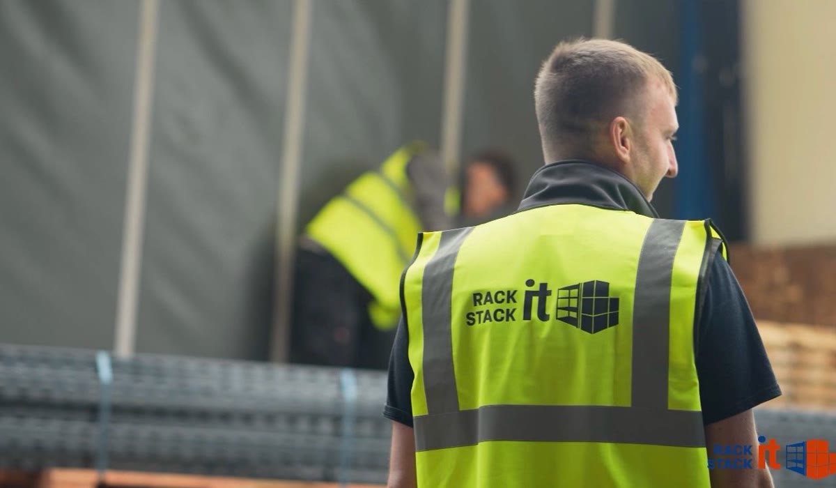 Rack It Stack It installer in a branded hi-vis vest on a customer site